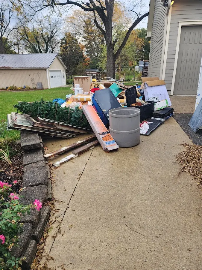 Dumpster being loaded with debris for Residential Dumpster Rental in Franklin